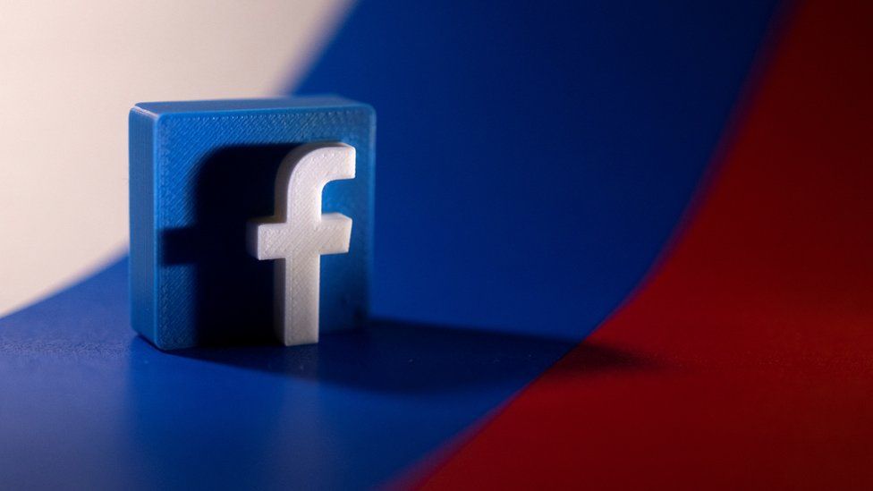 An image of the facebook logo and the russian flag.jpg